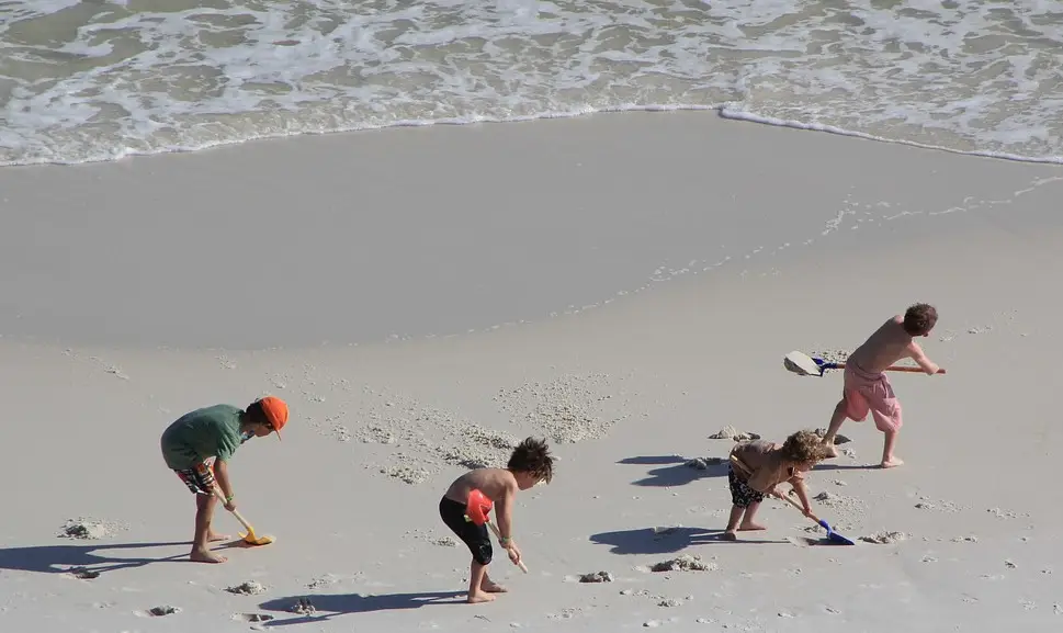 kids digging at beach playing