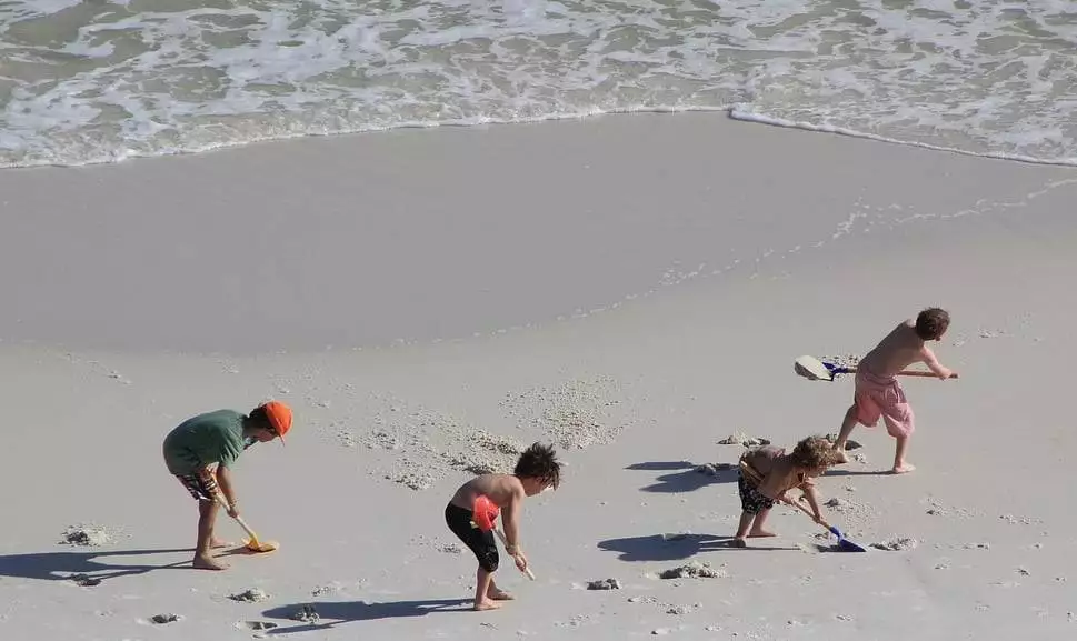 kids digging at beach playing