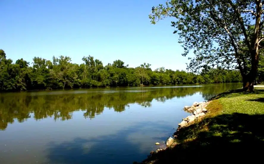 A State Park featuring a river surrounded by trees and grass.