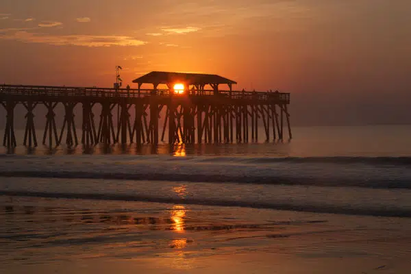 sunset over pier in state park near myrtle beach south carolina