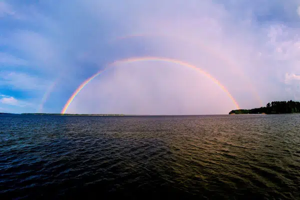 rainbow over the water at lakepoint state park in alabama