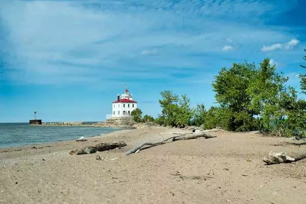 lighthouse on a beach in a state park near cleveland ohio