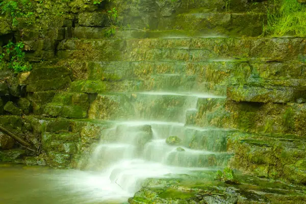 waterfall over amphitheater rock formation in a state park near dayton ohio