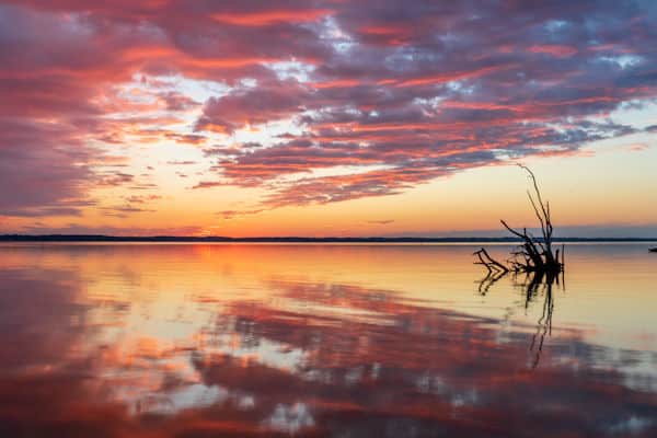sunset over the sea at belle island state park in virginia