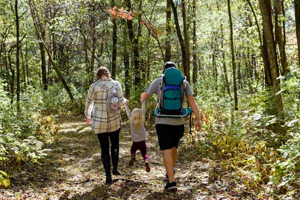 family hiking in the woods at caledon state park in viginia