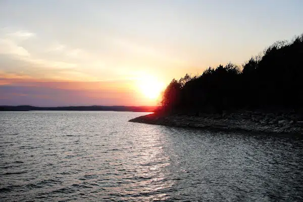 sunset over a lake at a state park near fayetteville arkansas