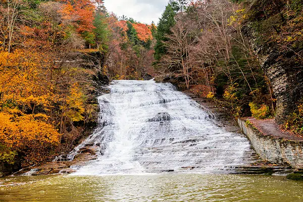 fall foliage by a waterfall in a state park near ithaca new york