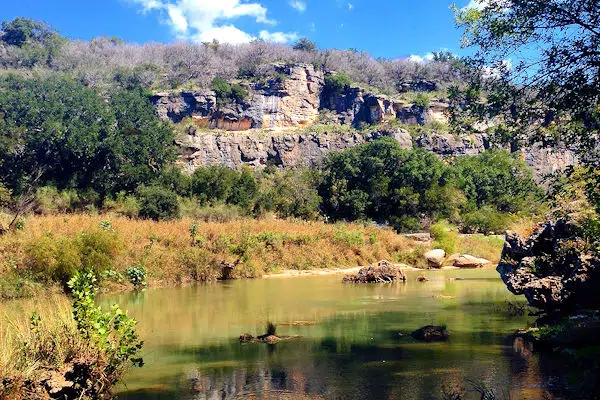 river by a rock formation in a state park near marble falls texas