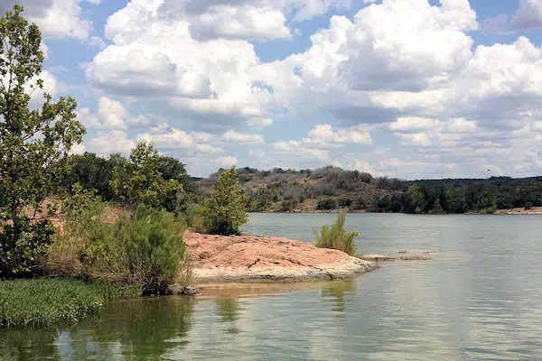 view of the water from a walking path in a state park near marble falls texas
