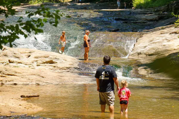 family enjoying a sliding rock at a state park near hiawassee georgia