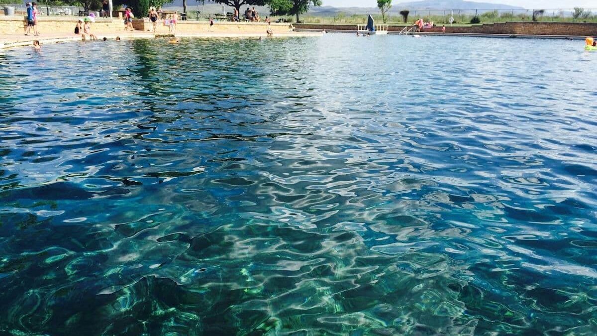 A State Park featuring a pristine lake with clear water where people can swim.