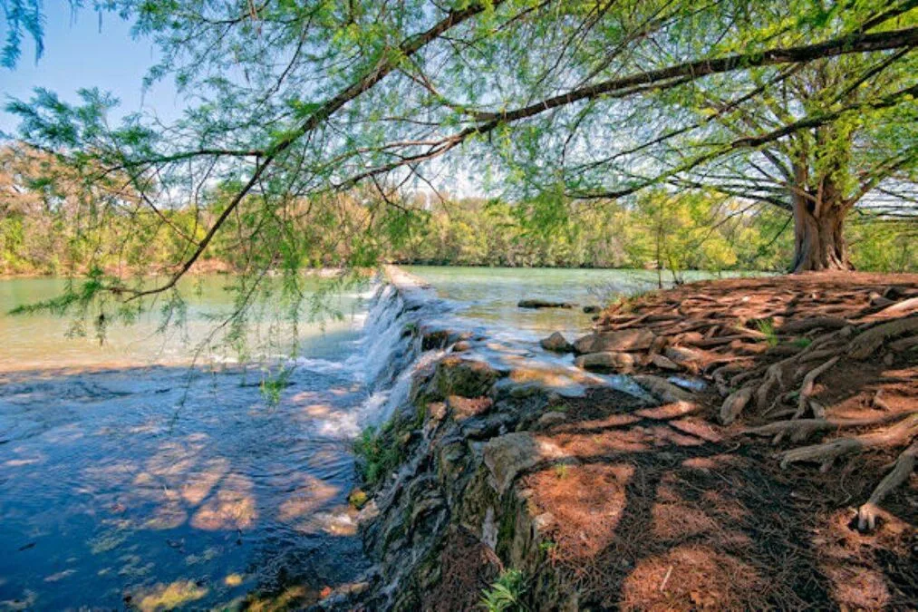 a shot of the waterfall from the river's edge at Blanco State Park in Texas