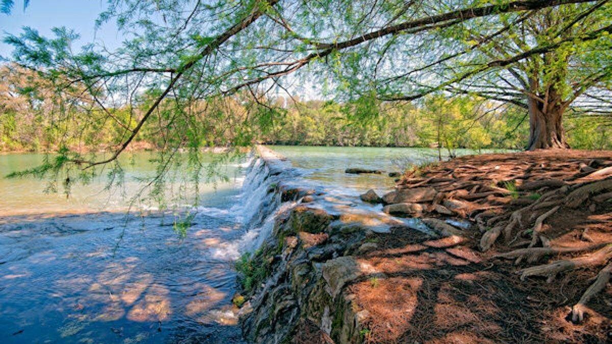 a shot of the waterfall from the river's edge at Blanco State Park in Texas