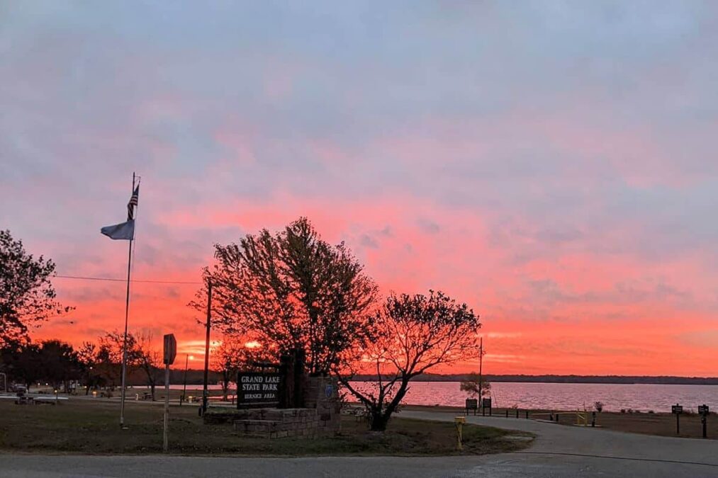 colorful sunrise over the water at bernice area grand lake state park in oklahoma