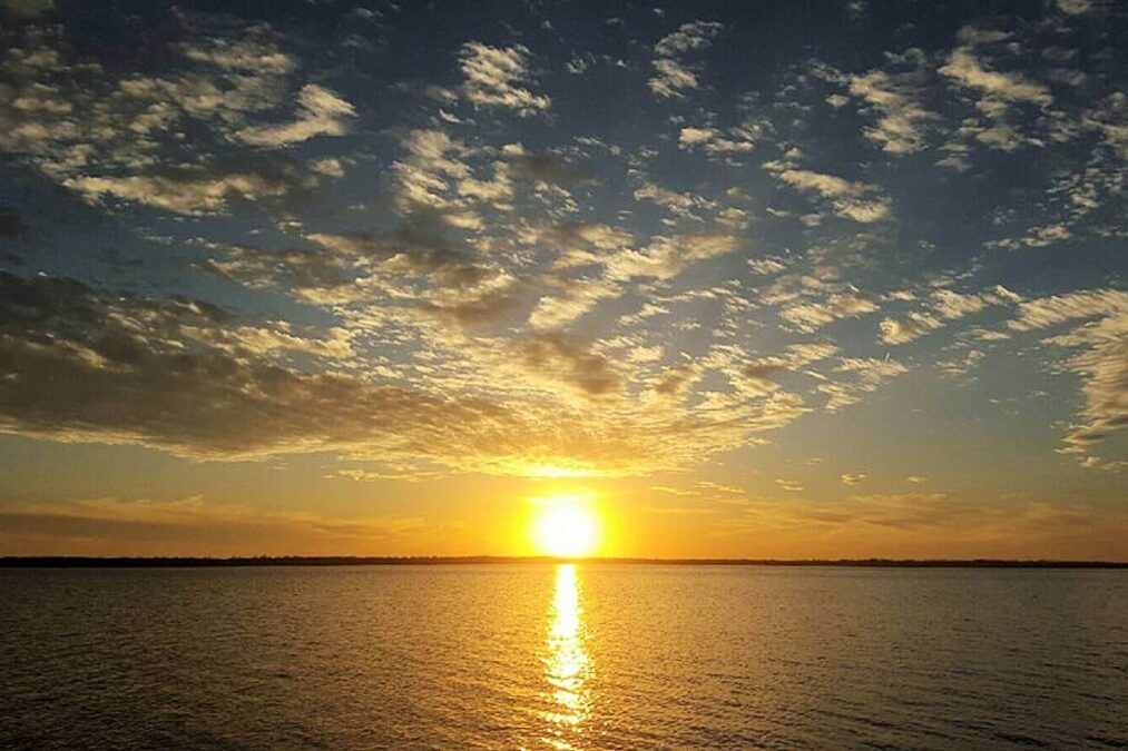 sunset below cloudy skies at lake eufaula state park in oklahoma