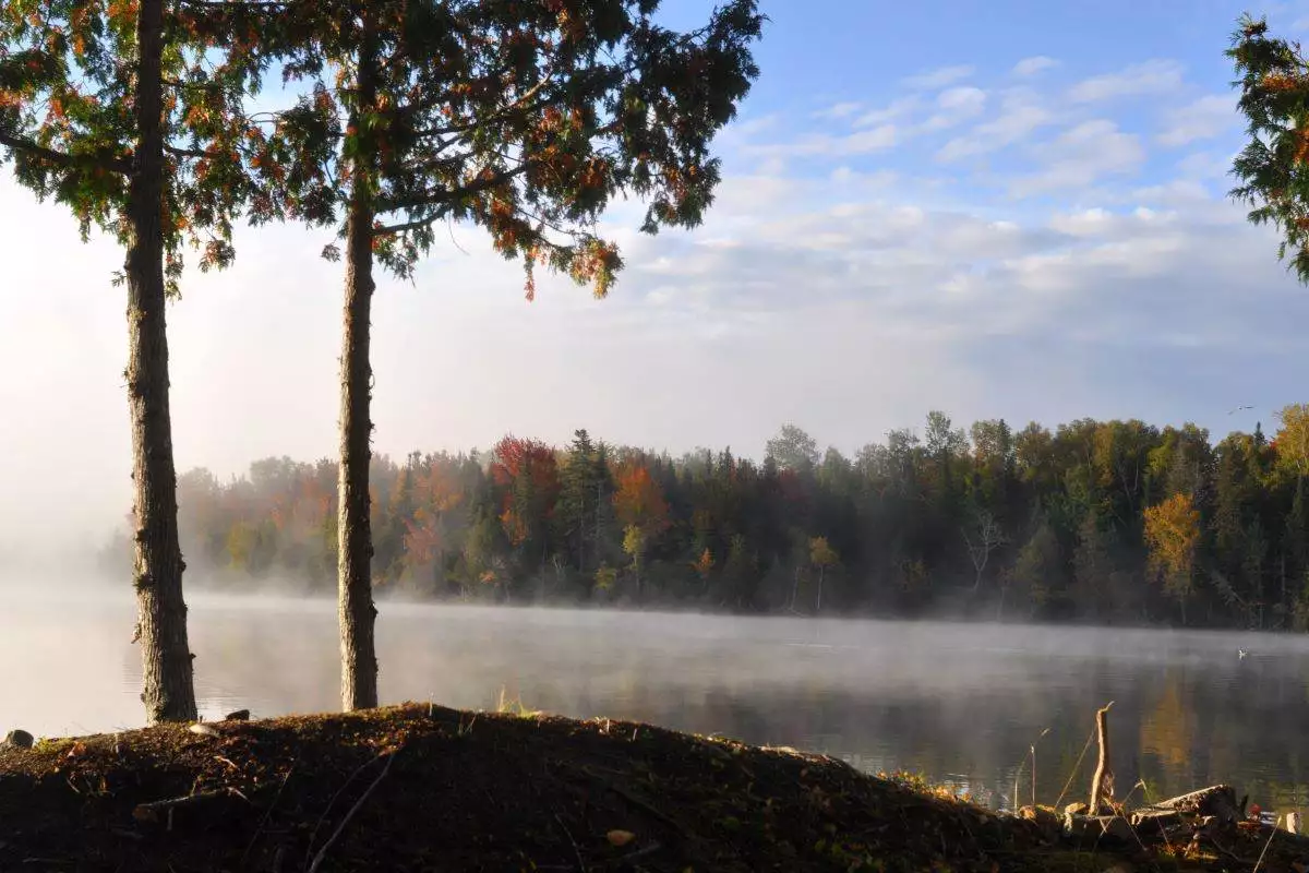 a view of fog over the water at Rangeley Lake State Park
