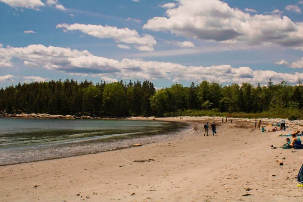 people walking on the beach at Birch Point State Park