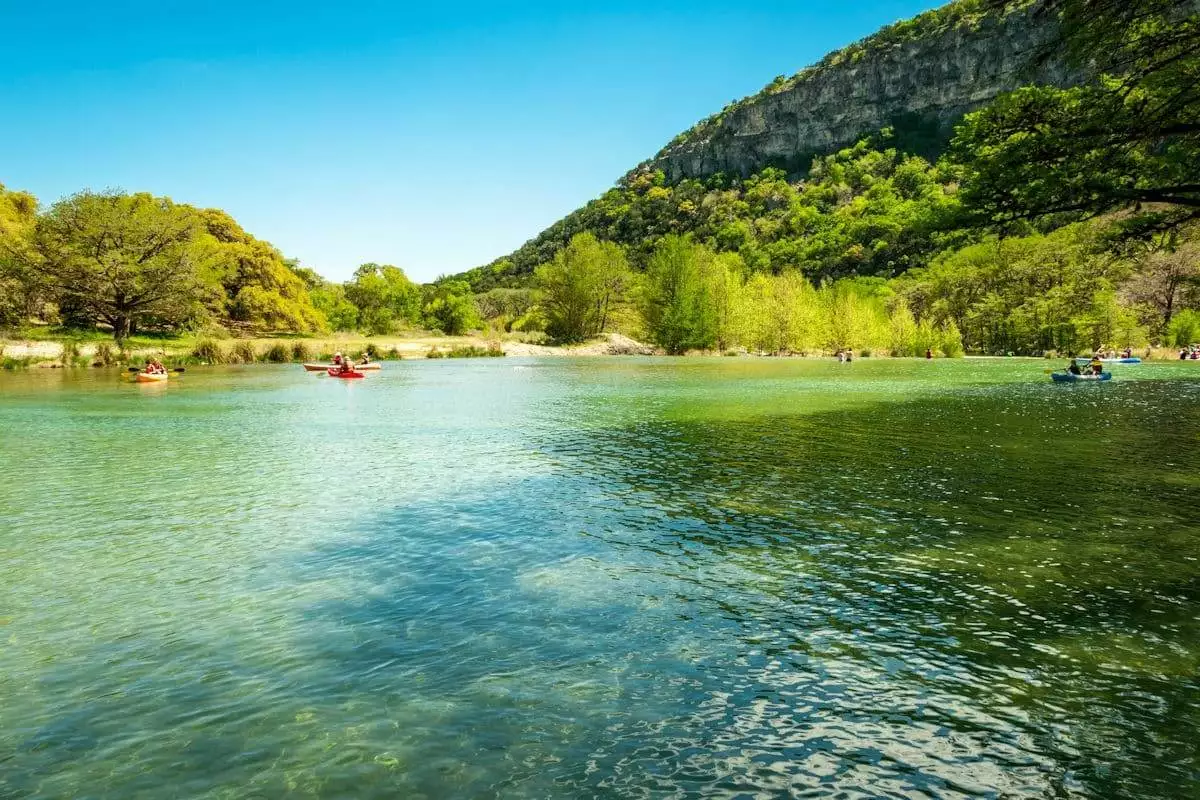 visitors paddling canoes at garner state park in texas