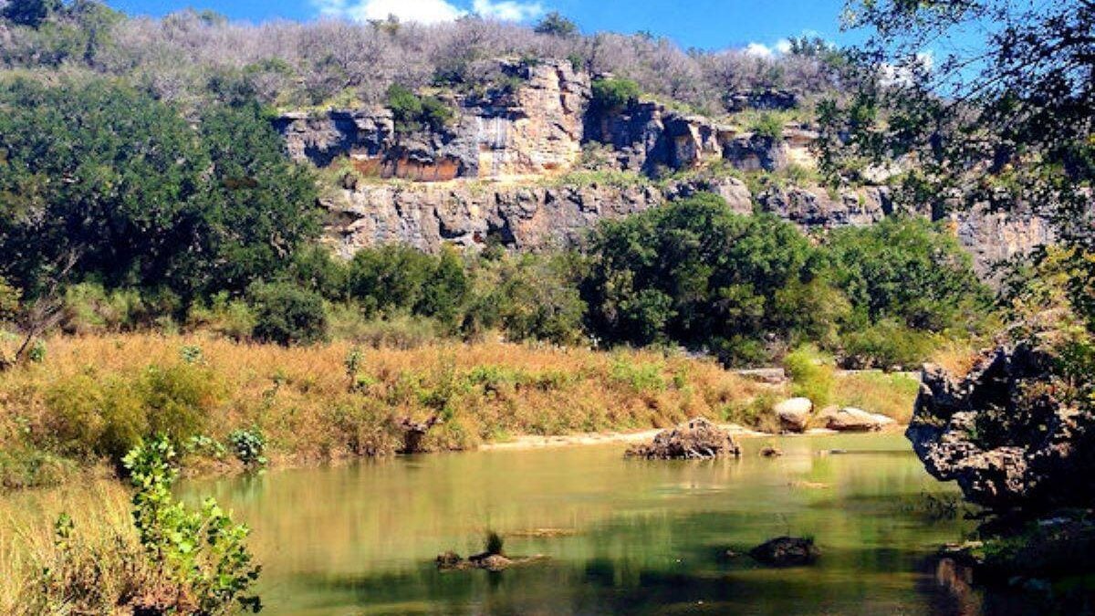 a rock hill behind the Colorado River at Colorado Bend State Park