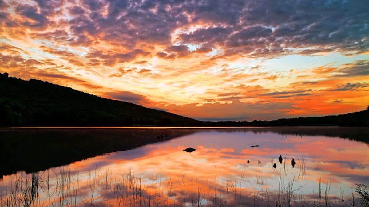 A cloudy sunrise at Locust Lake State Park, Schuylkill County, Pennsylvania, USA.