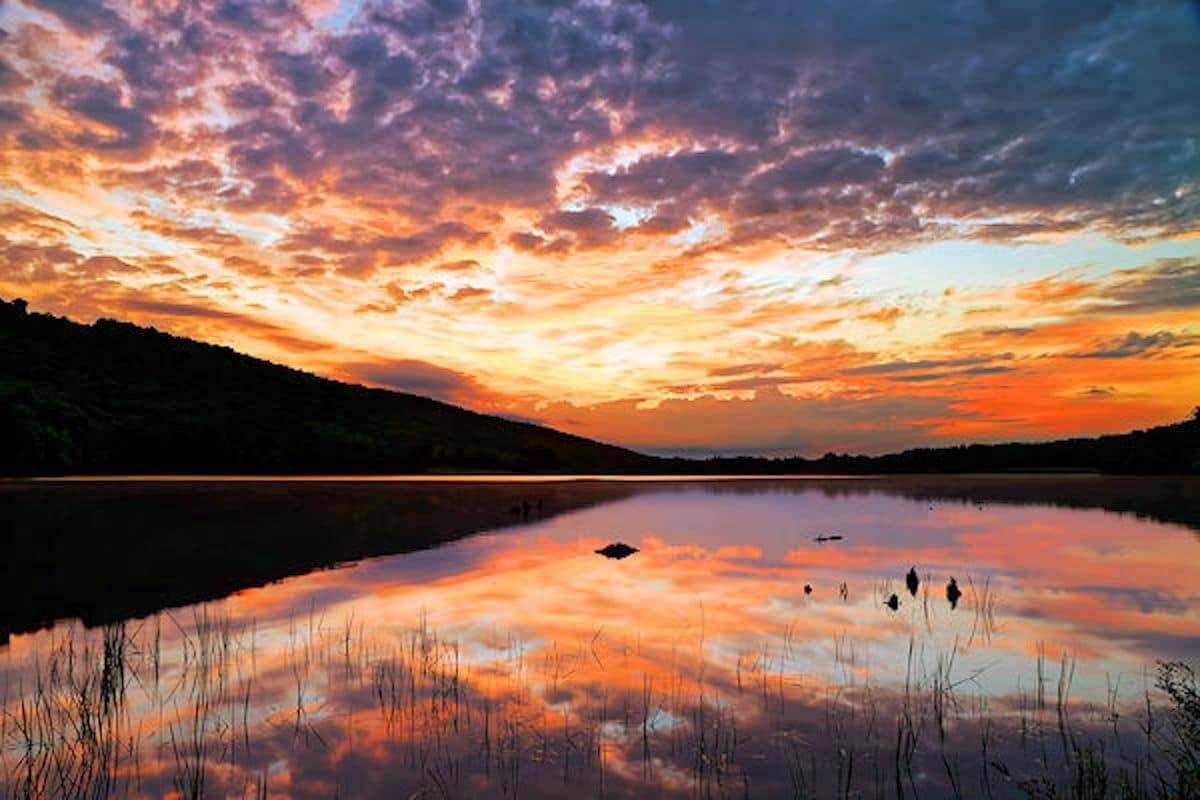 A cloudy sunrise at Locust Lake State Park, Schuylkill County, Pennsylvania, USA.