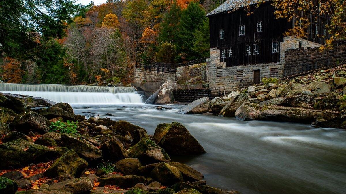 Rustic Mill Adjacent to Rushing Stream in Peak Autumn Season in McConnells Mill State Park