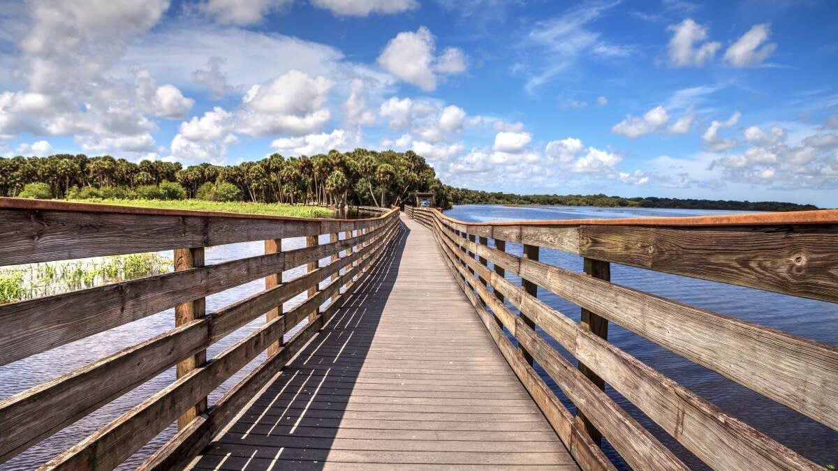 A wooden walkway leading to a body of water in a State Park.