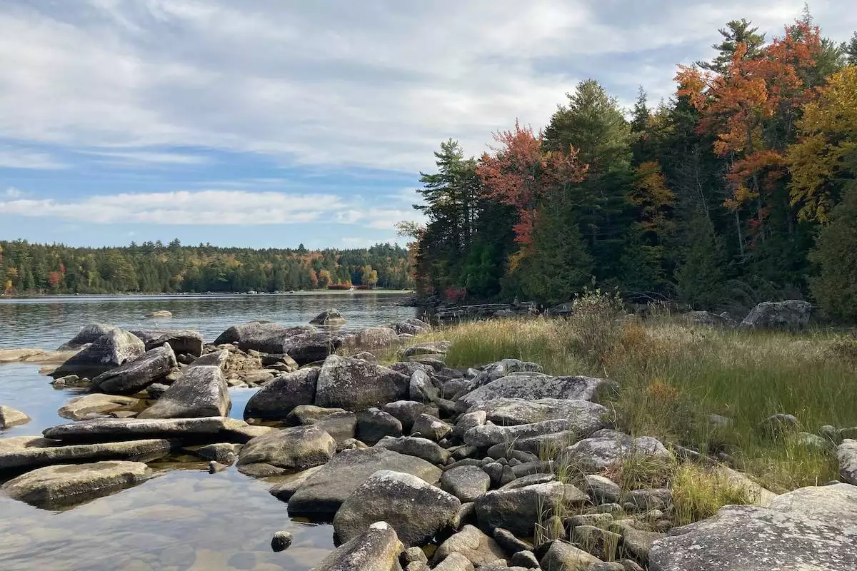 rocks in Sebec Lake with Peaks-Kenny State Park in the background