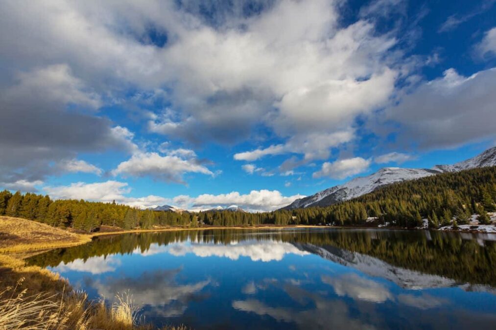 clouds reflected on the surface of a lake in a state park near breckenridge colorado