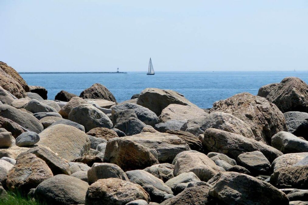 sailboat off the rocky shore of a state park near stamford connecticut