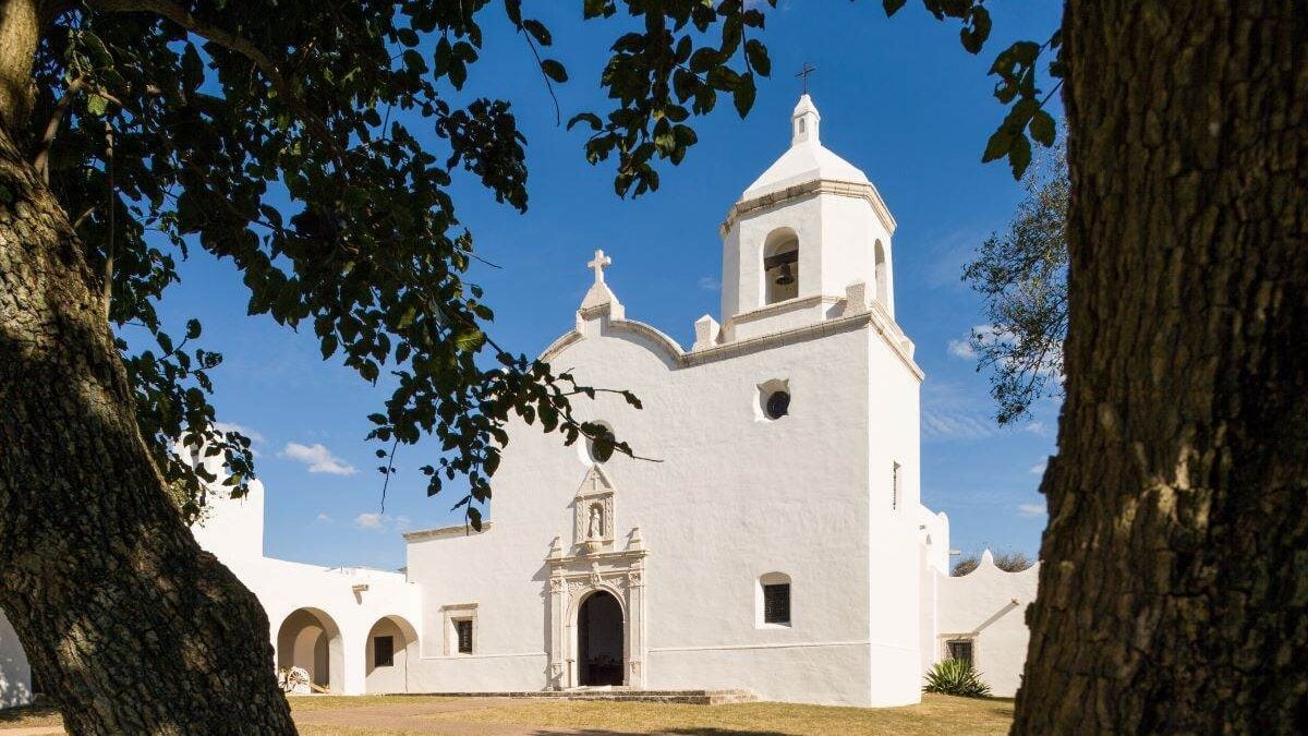 Mission Esperitu Santo through the trees at Goliad State Park