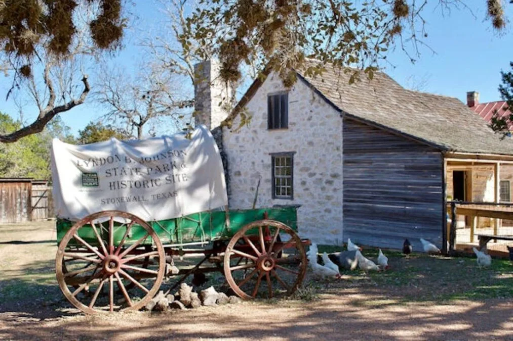 Antique wagon in front of historic building at Lyndon B. Johnson State Park