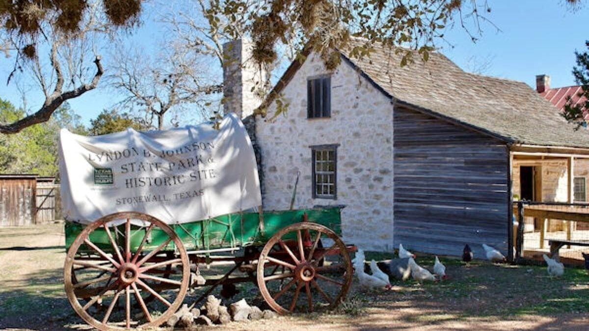 Antique wagon in front of historic building at Lyndon B. Johnson State Park