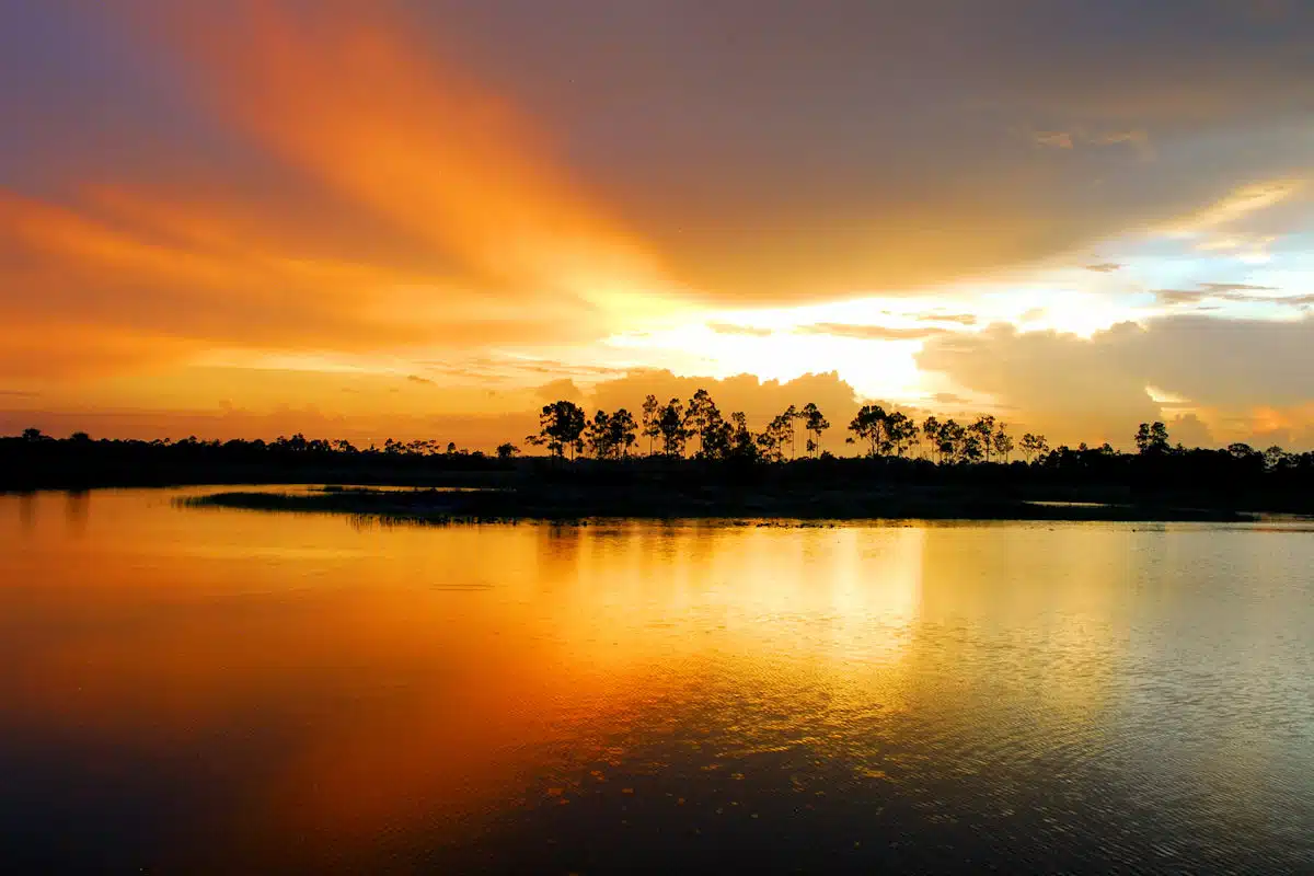orange sunset over the water at a state park near panama city florida