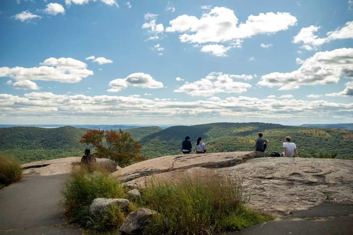 people admiring the view from the top of Bear Mountain