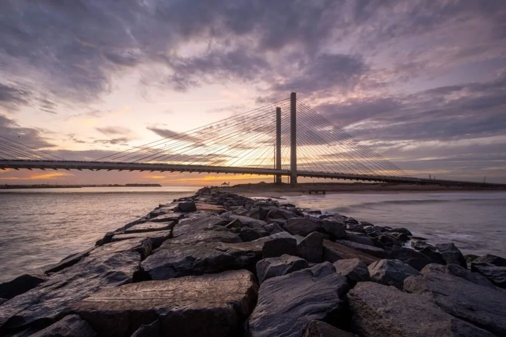 View of the bridge at Delaware Seashore State Park at sunset