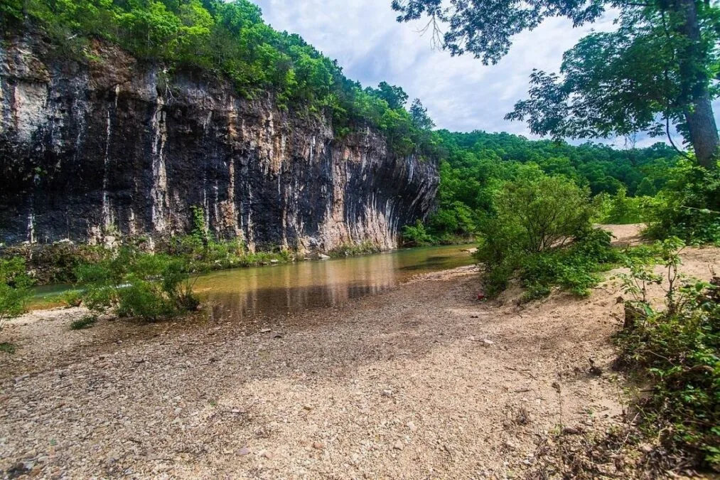 Cliff towering over Sinking Creek at Echo Bluff State Park