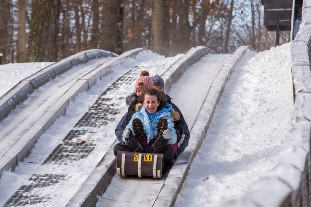Pokagon State Park 24 kids riding a toboggan at a state park