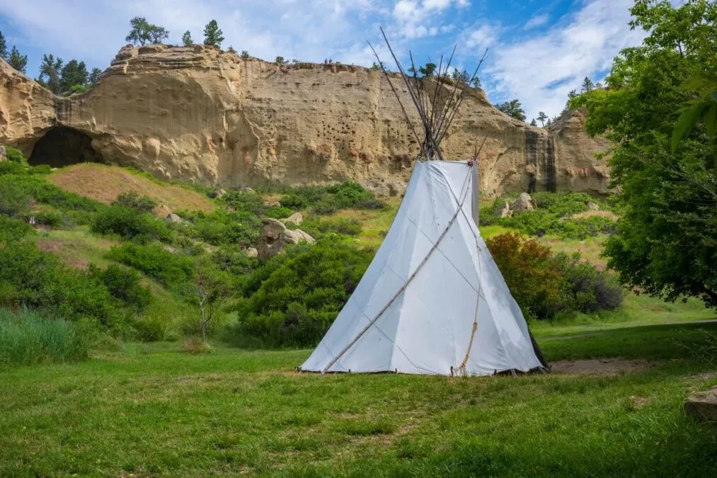 Native American tipi outside of a cave at Pictograph Cave State Park