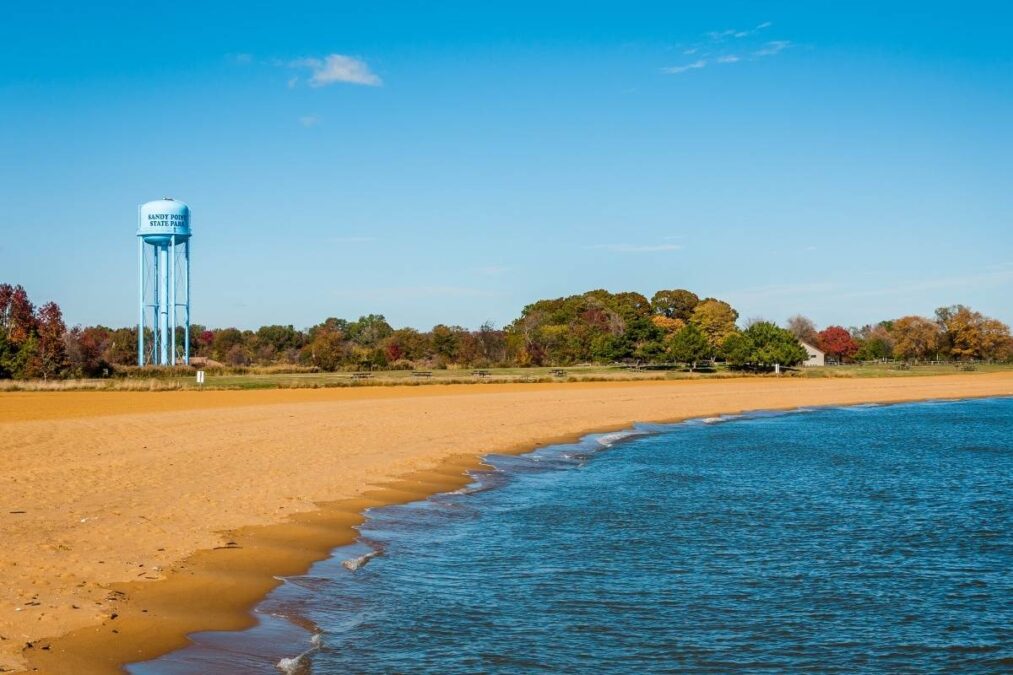 the beach at Sandy Point State Park with a water tower in the background