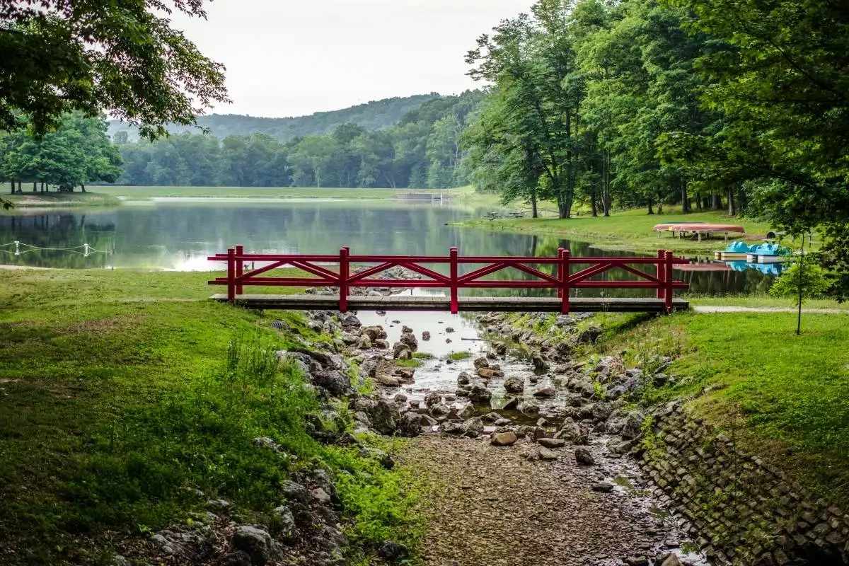 a bridge in front of the lake at Scioto Trail State Park