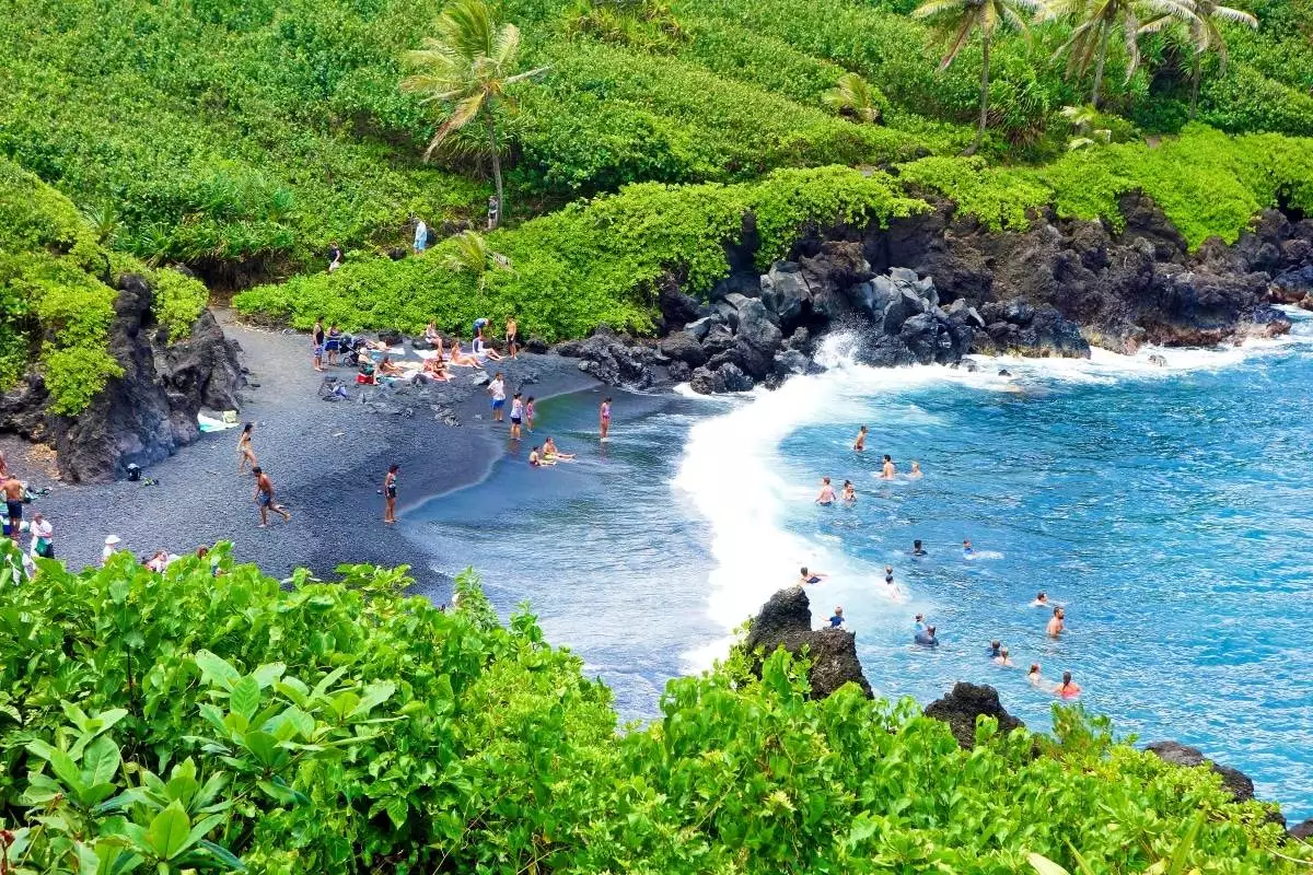 people enjoying the beach at Wai‘anapanapa State Park