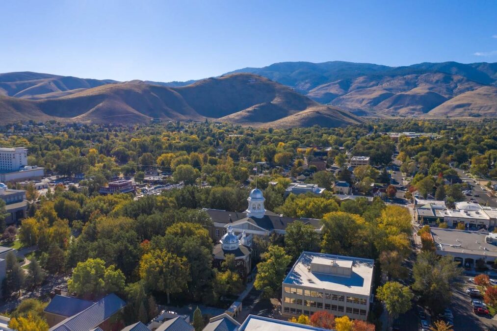 A view of Nevada's state capitol building and capitol mall area in Carson City with the Sierra Nevada mountains in the background.