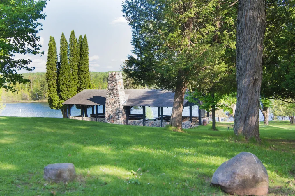 Stone-chimney picnic shelter on the lakeshore lawn at Bewabic State Park, Michigan