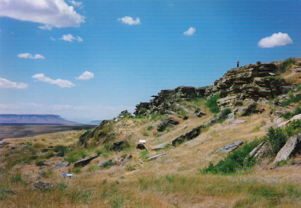 First Peoples Buffalo Jump State Park 7 Sandstone cliff of the buffalo jump above grassy slopes and plains, First Peoples Buffalo Jump State Park, Montana