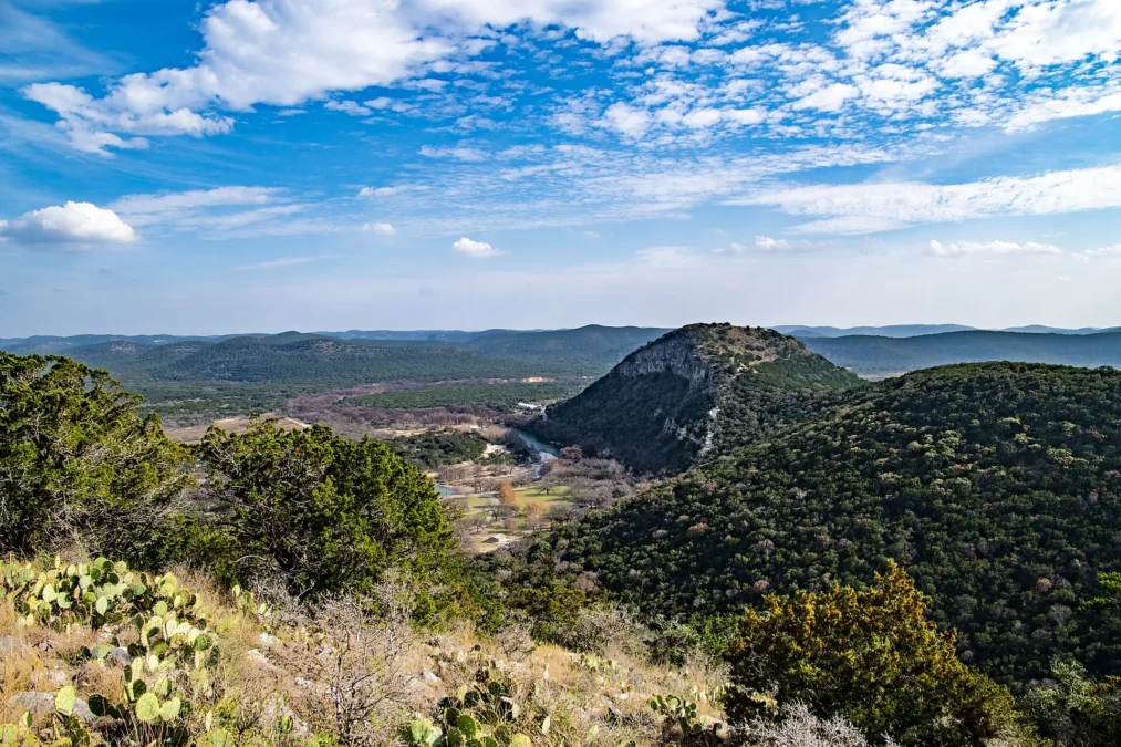 Garner State Park 38 Frio River valley and wooded Hill Country ridges seen from a rocky overlook with prickly pear, Garner State Park, Texas