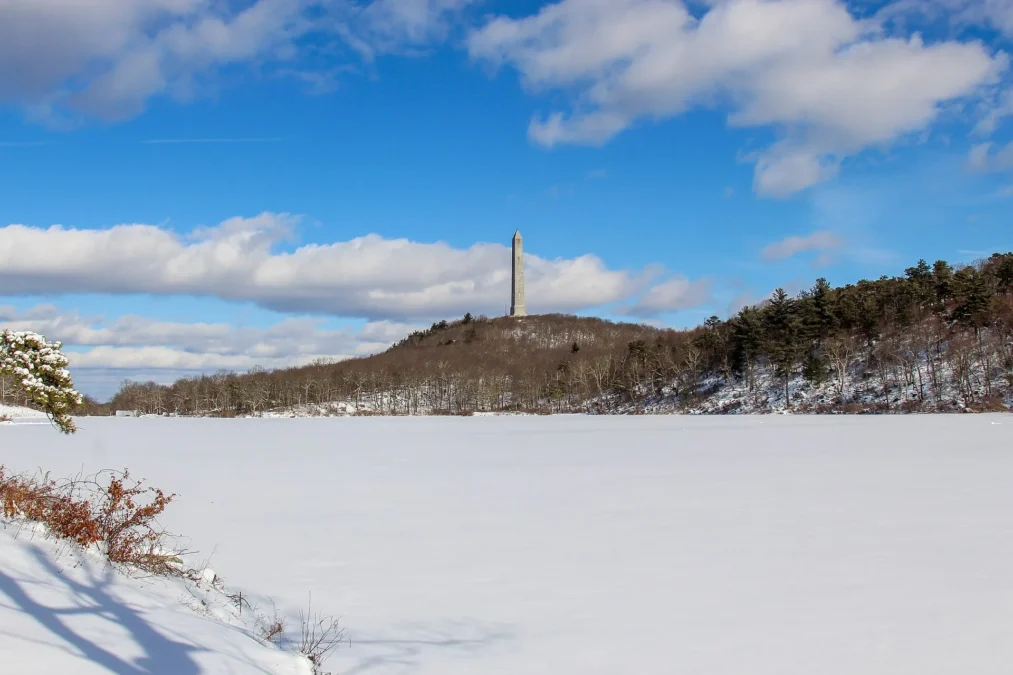 High Point Monument above snow-covered Lake Marcia at High Point State Park, New Jersey