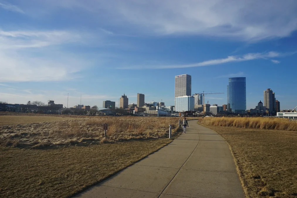 Paved path through prairie grasses toward the Milwaukee skyline, Lakeshore State Park, Wisconsin