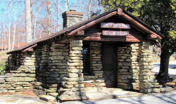 Pickett CCC Memorial State Park 48 Stone CCC Museum building with a chimney among bare trees, Pickett CCC Memorial State Park, Tennessee