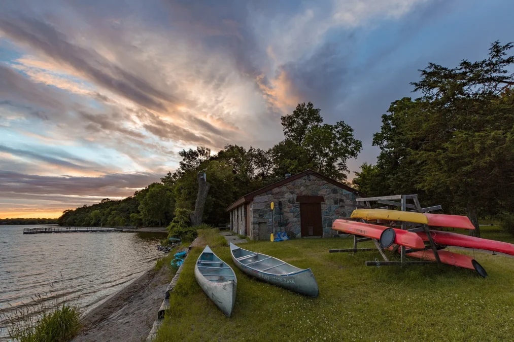 Boathouse with canoes and kayaks on Andrew Lake in Sibley State Park, Minnesota